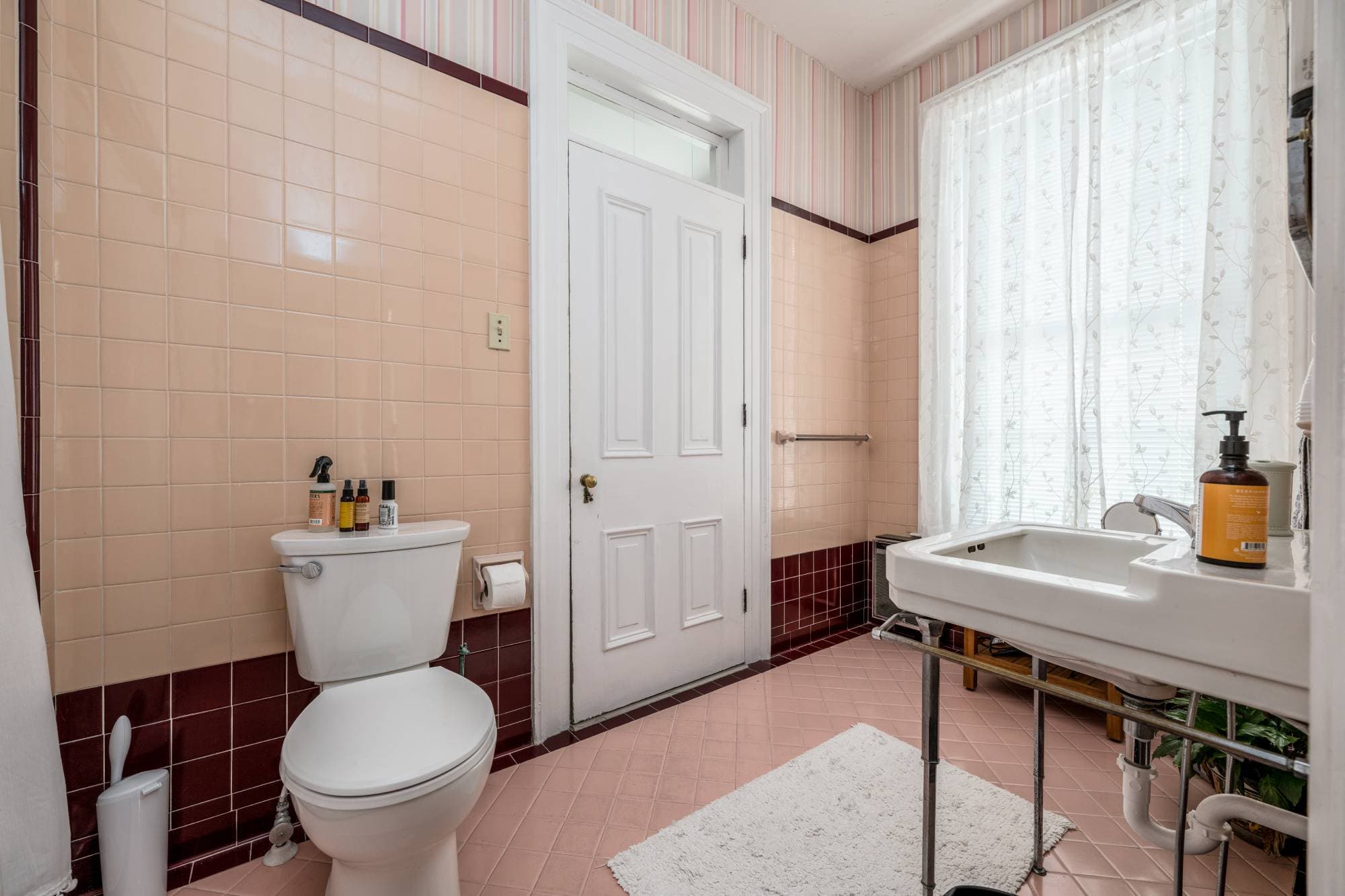 Large bathroom with pink and black tile