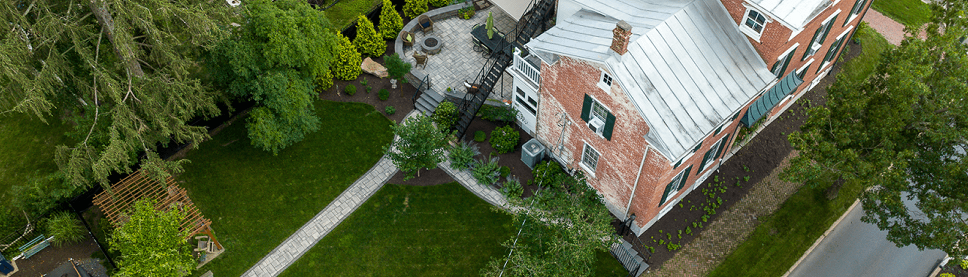 Aerial view of the back yard of Elmdale Inn, Green grass and trees